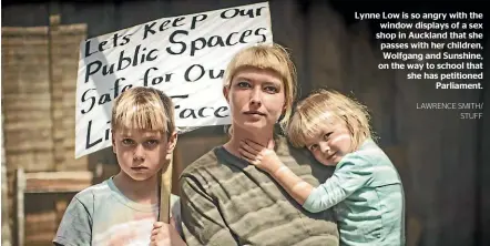  ?? LAWRENCE SMITH/ STUFF ?? Lynne Low is so angry with the window displays of a sex shop in Auckland that she passes with her children, Wolfgang and Sunshine, on the way to school that she has petitioned Parliament.