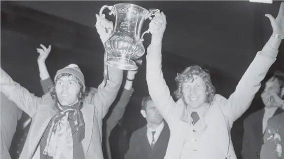  ??  ?? Two Sunderland legends, Ian Porterfiel­d and Jimmy Montgomery, with the FA Cup after the 1-0 win over Leeds United at Wembley in 1973.