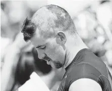  ?? David Zalubowski / Associated Press ?? Broncos rookie linebacker Josey Jewell displays the haircut that was the work of the veterans while signing autographs after a joint session with the Bears on Wednesday at Englewood, Colo.