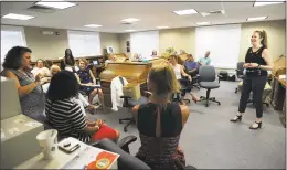  ??  ?? Manager Nancy Pantoliano, right, leads the bimonthly staff meeting on Sept. 6.