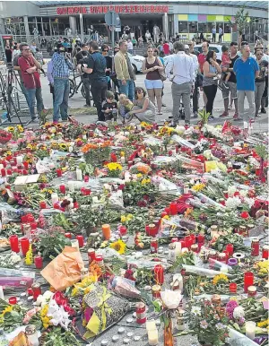  ?? Picture: Getty. ?? Floral tributes have been left near the Munich shopping centre where the attack took place on Friday.