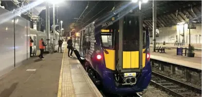  ?? PHILIP HAIGH. ?? ScotRail 385103 waits at Glasgow Queen Street before leaving with February 6’s 2107 test run to Edinburgh. It arrived on time at 2212, having stopped at six stations and been held for red signals on a schedule that included 15 minutes of pathing time....