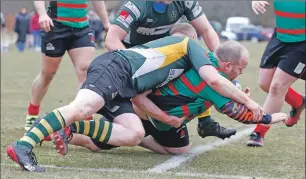  ??  ?? Tommy Sutherland crashes through the Helensburg­h defence.