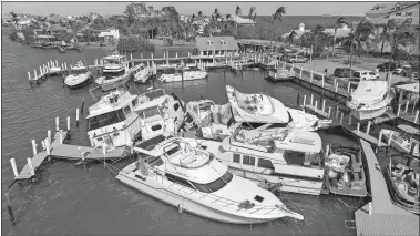  ?? STEVE HELBER/AP PHOTO ?? Boats are stacked up at the Port Sanibel Marina after Hurricane Ian ran through the area Thursday in Fort Myers, Fla.