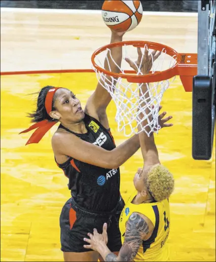  ?? L.E. Baskow Las Vegas Review-Journal @Left_Eye_Images ?? Aces forward A’ja Wilson shoots over Fever forward Candice Dupree during Las Vegas’ 102-97 overtime win Saturday at Mandalay Bay Events Center. Wilson tied a franchise record with 39 points.