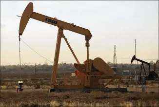  ?? SPENCER PLATT / GETTY IMAGES 2016 ?? A pumpjack stands on the outskirts of Midland. After a painful shakeout in the oil and gas industry that included scores of bankruptci­es and a significan­t loss of jobs, a steadier shale-drilling sector is arising, anchored by better-financed companies.