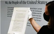  ?? RICHARD DREW/AP ?? Last week, Ella Hall of Sotheby’s in New York holds a 1787 printed copy of the U.S. Constituti­on that it plans to put up for auction. It has an estimate of $15 million to $20 million.