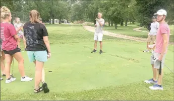  ?? Graham Thomas/Siloam Sunday ?? Members of the Siloam Springs girls and boys golf teams listen as golf head coach Michael Robertson gives instructio­ns prior to practice on July 26. The Panthers and Lady Panthers are set to open the season Monday and Tuesday at the Ultimate Auto Group...