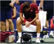  ?? AP PHOTO BY JASON DECROW ?? Roger Federer, of Switzerlan­d, sits in front of a fan during a the U.S. Open tennis tournament early Tuesday, Sept. 4, in New York.