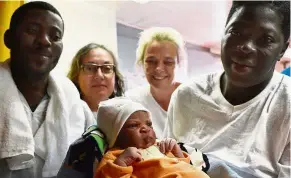  ?? — AFP ?? Ship-shape: Bernadette Obiona (right) and David Dibonde (left) posing with their newborn Alex during a family picture with nurse Angelina Perri (second left) and doctor Erna Rijnierse on May 25, 2016, a day after a rescue operation of migrants off the...