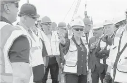  ?? JENNIFER MCDERMOTT/AP ?? U.S. Energy Secretary Jennifer Granholm tours the New London State Pier facility May 20 to view progress on a hub for the offshore wind power industry.