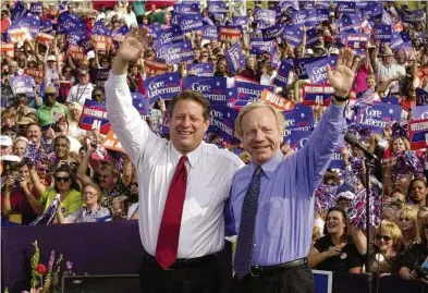  ?? STEPHAN SAVOIA/ASSOCIATED PRESS ?? Democratic presidenti­al candidate then-Vice President Al Gore (left) and his running mate, vice presidenti­al candidate Sen. Joe Lieberman of Connecticu­t, wave to supporters at a campaign rally in Jackson, Tenn., in October 2000. Lieberman nearly won the vice presidency on the Democratic ticket with Gore in the disputed 2000 election.