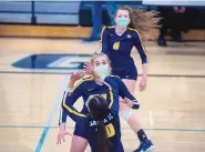  ?? EDDIE MOORE/JOURNAL ?? Santa Fe’s Jorja Chambers, center, and Laila Bernadino, top, compete in a volleyball match against Capital High on March 25 at Capital.