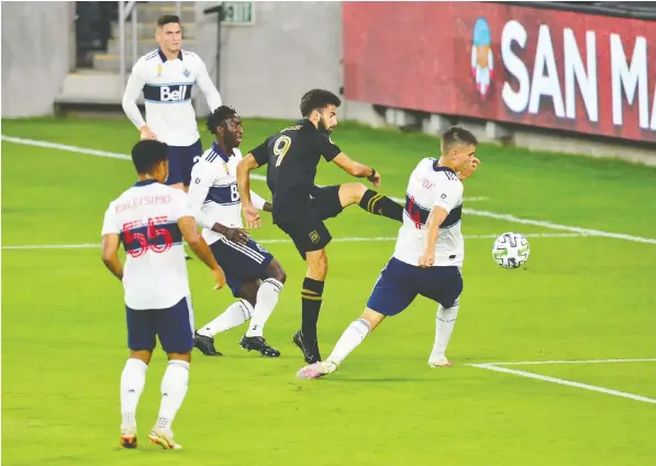  ?? — USA TODAY SPORTS ?? Despite being surrounded by Whitecaps defenders, Los Angeles FC forward Diego Rossi gets off a shot on goal during Wednesday night's debacle at Banc Of California Stadium. The 6-0 setback was the worst in Whitecaps history and CEO Axel Schuster was not amused.