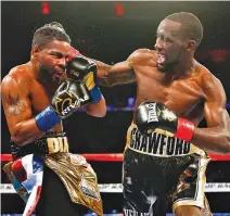  ?? AFP ?? TERENCE CRAWFORD (R) connects with Felix Diaz during their WBO/WBC junior welterweig­ht title bout at Madison Square Garden on May 20 in New York City.