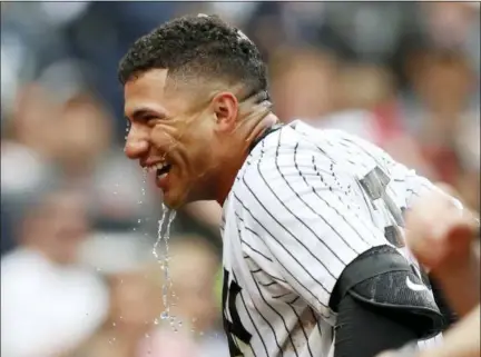  ?? KATHY WILLENS — THE ASSOCIATED PRESS ?? New York Yankees’ Gleyber Torres drips with ice water after teammates doused him with a bucket of it after Torres hit a ninth-inning, walkoff, three-run, home run in a baseball game against the Cleveland Indians in New York, Sunday.