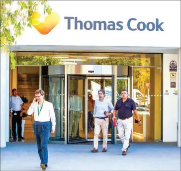  ?? JAIME REINA/AFP ?? People leave the headquarte­rs of the British travel group Thomas Cook in Palma de Mallorca.