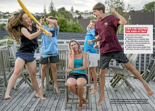  ?? PETER MEECHAM/STUFF ?? Nikola Sutton (seated) from Auckland is driven nuts by the holiday antics of her children and friends from left: Grace, Hunter, Oliver and Max.