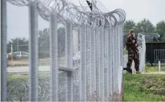  ??  ?? A Hungarian soldier patrols at the transit zone at Hungary’s southern border with Serbia near Tompa, 169 km southeast of Budapest, Hungary. Hungary’s Prime Minister Viktor Orban, an early supporter of US President Donald Trump, has ordered the...