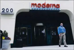  ?? BILL SIKES — THE ASSOCIATED PRESS FILE ?? A man stands outside an entrance to a Moderna Inc. building in Cambridge, Mass., on May 18.