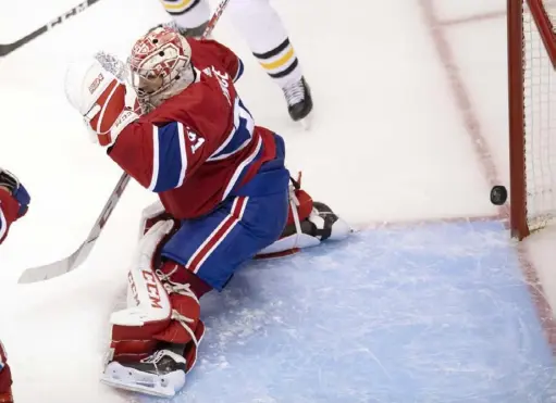  ?? Associated Press ?? The puck hits the post behind Canadiens goaltender Carey Price in the third period Friday in Toronto. It was that kind of night for the Penguins, who are now just 1-9 in their past 10 playoff games.