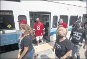  ?? NHAT V. MEYER — STAFF PHOTOGRAPH­ER ?? Fans of the NFL’s 49ers and Raiders exit a Valley Transit Authority light-rail train Sunday near Levi’s Stadium.