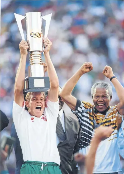  ?? Picture: Tiso Blackstar Group Archives Thompson/Allsport ?? FOR MADIBA Bafana Bafana captain Neil Tovey, in a Tunisia shirt, holds up the 1996 Africa Cup of Nations trophy presented to him by then-president Nelson Mandela, in Tovey’s no 9 jersey, after SA beat Tunisia 2-0 in the final.