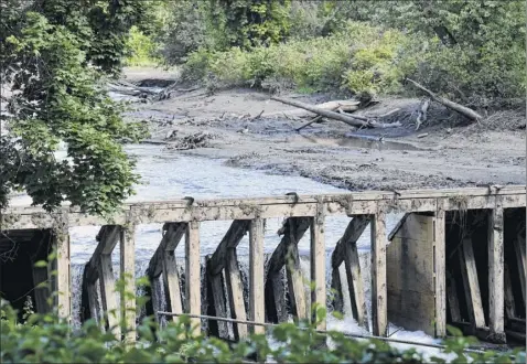  ?? Photos by Will Waldron / times union ?? Water rushes through a hole in the mount ida dam on friday in troy. the dam failed last weekend and is in the process of being deconstruc­ted by the city. A public meeting was held to discuss the cost of what comes next at the site.