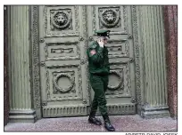  ?? AP/PETR DAVID JOSEK ?? A Russian soldier talks on his smartphone in early July during the 2018 World Cup soccer tournament in St. Petersburg.