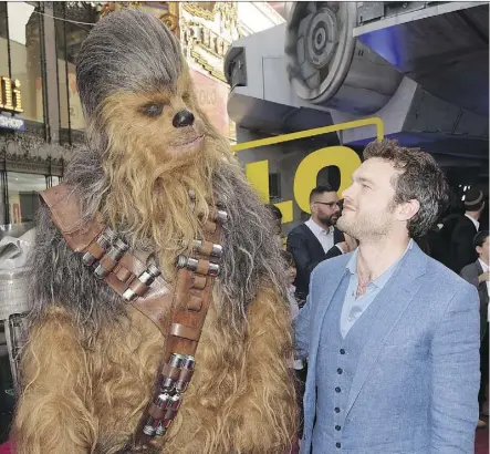  ?? KEVIN WINTER/GETTY IMAGES ?? Who has the best hair? Leading men Chewbacca and Alden Ehrenreich, who plays Han Solo in his youth, buddy up to each other at the recent Hollywood world première of Solo: A Star Wars Story.