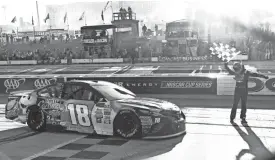  ?? JERRY MARKLAND/GETTY IMAGES ?? Kyle Busch celebrates with the checkered flag after winning the Apache Warrior 400 on Sunday at Dover Internatio­nal Speedway in Dover, Delaware.