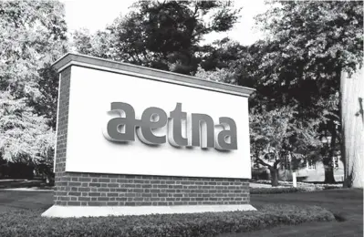  ?? Associated
Press file photo ?? ABOVE: A sign stands on the campus of the Aetna headquarte­rs on June 1, 2017, in Hartford, Conn. Some major health insurers plan to take a little sting out of prescripti­on drug prices by giving customers rebates at the pharmacy counter,
and they could...