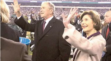  ??  ?? Former president of the United States George W. Bush (left) and his wife Laura Bush on the field before a game between the Philadelph­ia Eagles and the Dallas Cowboys at Lincoln Financial Field. -— Photo by Bill Streicher-USA TODAY Sports