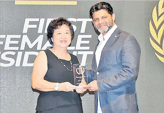  ?? Picture: REINAL CHAND ?? Jenny Seeto receives the ‘First Female President’ recognitio­n award from Acting Prime Minister Aiyaz Sayed-Khaiyum during the Fiji Institute of Accountant­s 50th anniversar­y celebratio­n at the Sofitel Fiji Resort and Spa on Denarau, Nadi.