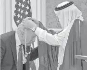  ?? Mandel Ngan/AFP/Getty Images ?? President Donald Trump receives a medal from Saudi Arabia’s King Salman bin Abdulaziz al-Saud at the Saudi Royal Court in Riyadh last week.