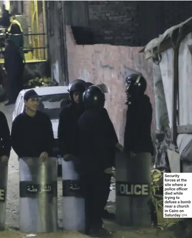  ?? EPA ?? Security forces at the site where a police officer died while trying to defuse a bomb near a church in Cairo on Saturday