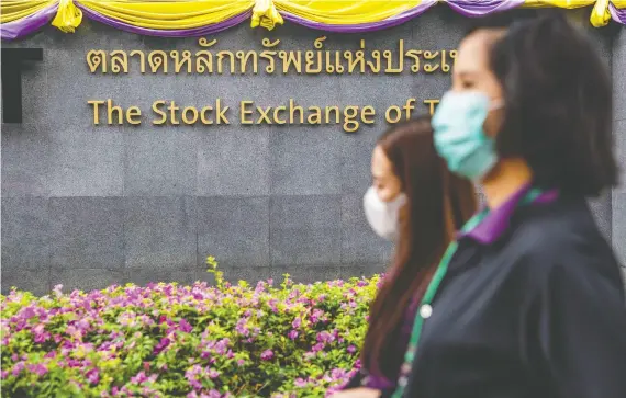  ?? LAUREN DECICCA/GETTY IMAGES ?? Outside the stock exchange of Thailand in Bangkok on Friday: the Thai market has plunged to its lowest since 2014.