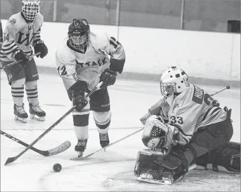  ?? FILE ?? Central Attack forward Cam Squires goes after a loose puck in front of Western goalie Nylan Hustler during early season action in the P.E.I. Bantam AAA Hockey League.