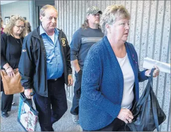  ?? THE CANADIAN PRESS/ANDREW VAUGHAN ?? Dwight Campbell, left, and his wife Susan Campbell, right, parents of slain Truro police officer Const. Catherine Campbell, head into a sentencing hearing dealing with parole eligibilit­y for Christophe­r Calvin Garnier, convicted of seconddegr­ee murder in her death, in Nova Scotia Supreme Court on Monday.