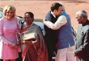  ?? AFP PIC ?? French President Emmanuel Macron (centre) is hugged by Indian Prime Minister Narendra Modi at a ceremonial reception in New Delhi yesterday. Looking on are Macron’s wife Brigitte (left), Indian President Ram Nath Kovind and his wife, Savita Kovind.