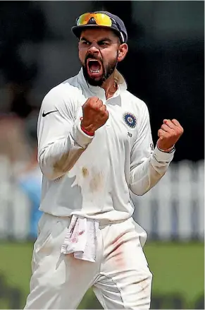  ??  ?? India’s Virat Kohli celebrates the wicket of Luke Ronchi in Kanpur yesterday.