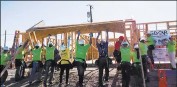  ?? COURTESY OF GLVAR ?? GLVAR volunteers help to frame a Habitat for Humanity home in Henderson that was completed in September.