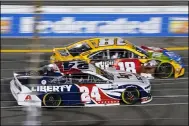  ?? STEVE HELBER — THE ASSOCIATED PRESS ?? William Byron (24) and Kyle Busch (18) during turn one at the NASCAR Cup serie race in Richmond, Va., on Sept. 11.