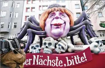  ?? PATRIK STOLLAR/AFP ?? A carnival float depicting Germa Chancellor Angela Merkel as a black widow sitting over the bones of German politician­s, during a carnival parade on Rose Monday, yesterday in Duesseldor­f, Germany.