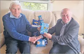  ?? ?? John Arnold handing over the food items to Pad Flynn.