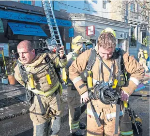  ??  ?? Firefighte­rs in South Street after tackling a blaze that started in a kitchen at the rear of St Andrews Shawarma House. Picture: Rick Booth.