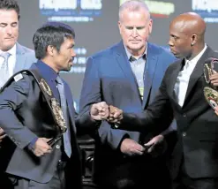  ?? —AFP ?? Pacquiao (left) and Yordenis Ugas of Cuba bump fists during the press conference in Las Vegas.