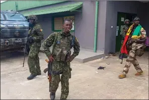  ?? (AP) ?? Soldiers patrol near the office of the president Sunday in Conakry, the capital of Guinea.