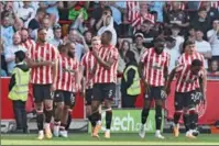  ?? (AFP) ?? Brentford’s English-born Jamaican defender Ethan Pinnock (C) celebrates with teammates after scoring a goal during the English Premier League match against d Manchester City in London on Sunday.