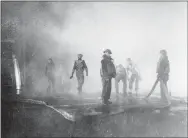  ?? VIA AP ?? In this June 4, 1942file photo, crewmen aboard the USS Yorktown battle fire after the carrier was hit by Japanese bombs, during the Battle of Midway. Later the vessel had to be abandoned and was sunk by a Japanese submarine torpedo hit. A group of deep-sea explorers scouring the world’s oceans for sunken World War II ships is honing in on sonar readings of debris fields in the Pacific Ocean. A research vessel called the Petrel is launching underwater robots about halfway between the U.S. and Japan in search of warships from the Battle of Midway.